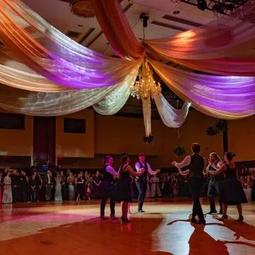 six students in the center of the ballroom at V Ball 